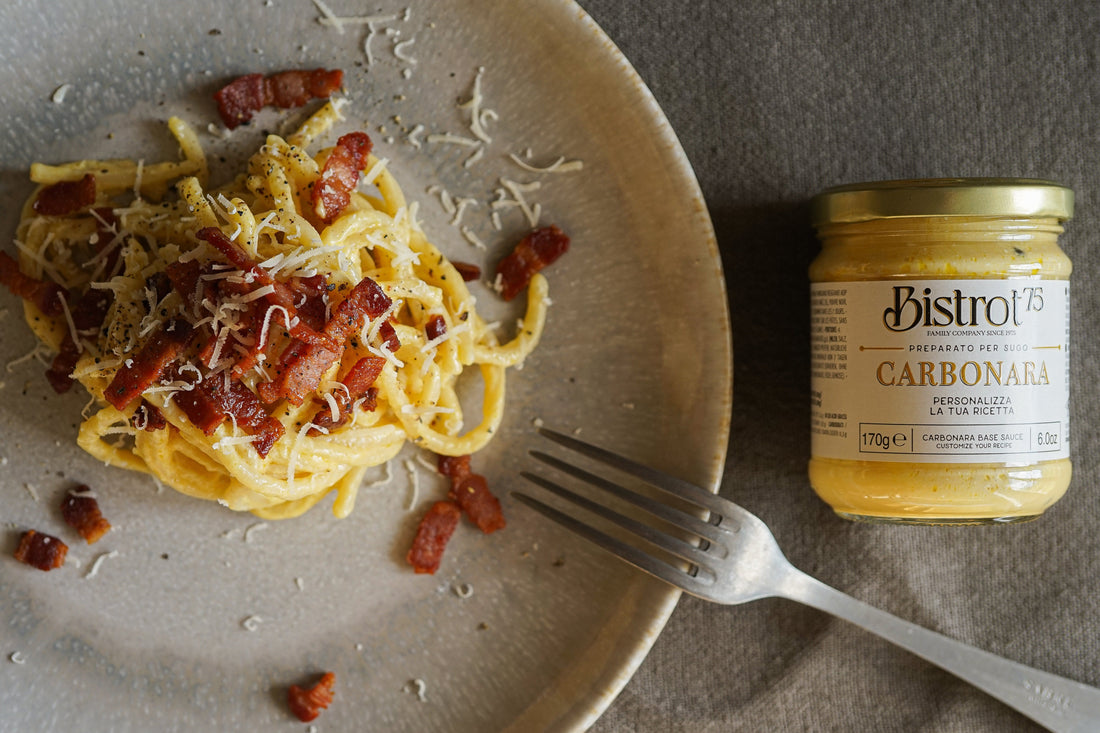 Creamy Carbonara Pici pasta topped with crispy pancetta, Parmigiano Reggiano, and a drizzle of Taggiasca olive oil.