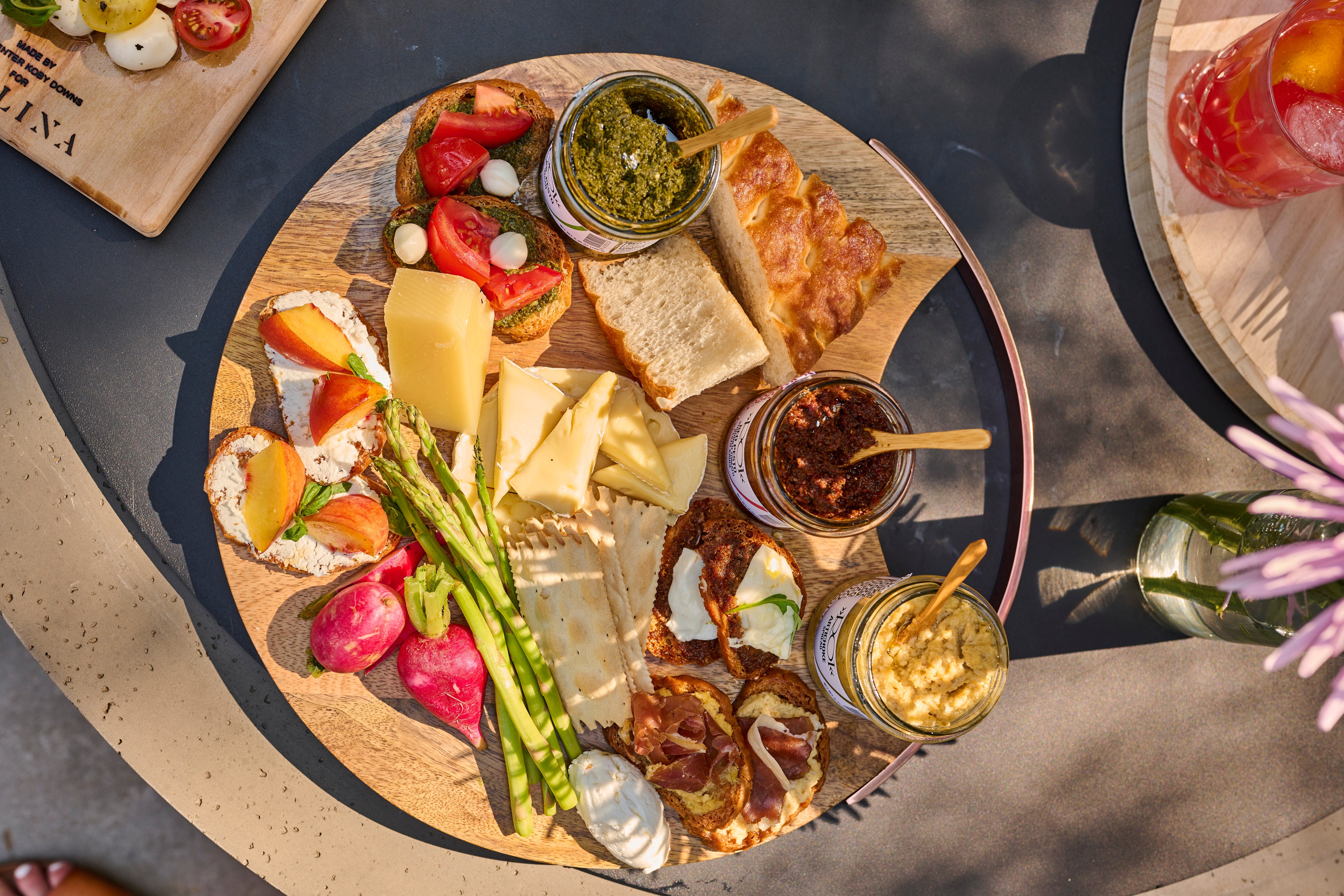 Antipasti board with cured meats, cheeses, olives, and crostini on a wooden platter