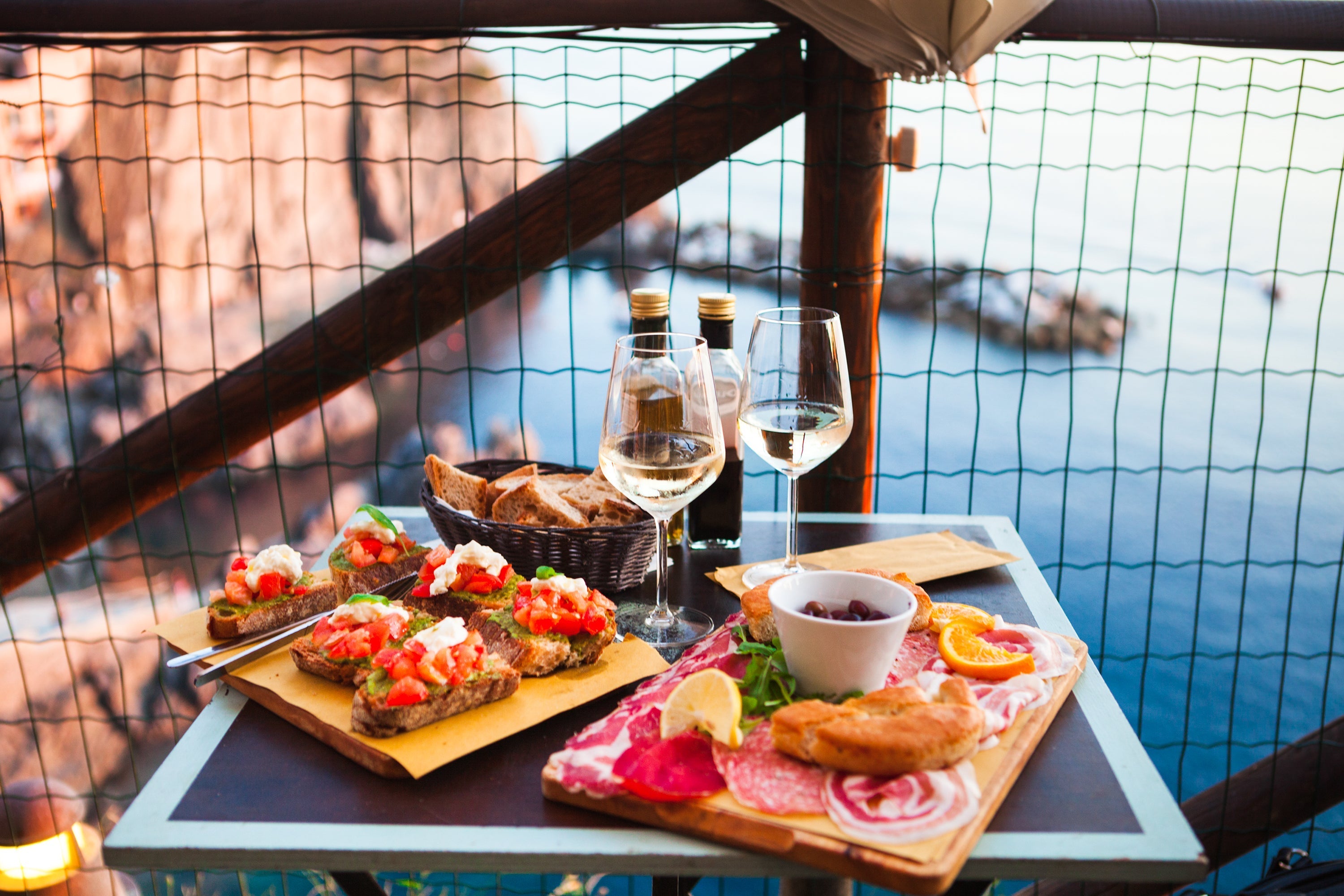 Summer in Italy concept with scenic landscapes, regional food specialties, and artisan products like olive oil, pasta, and balsamic vinegar.