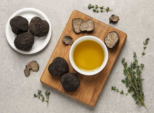 Fresh truffles, oil in bowl and thyme