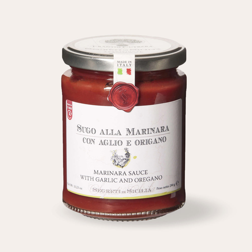 Jar of Sicilian marinara sauce with garlic and oregano on beige background