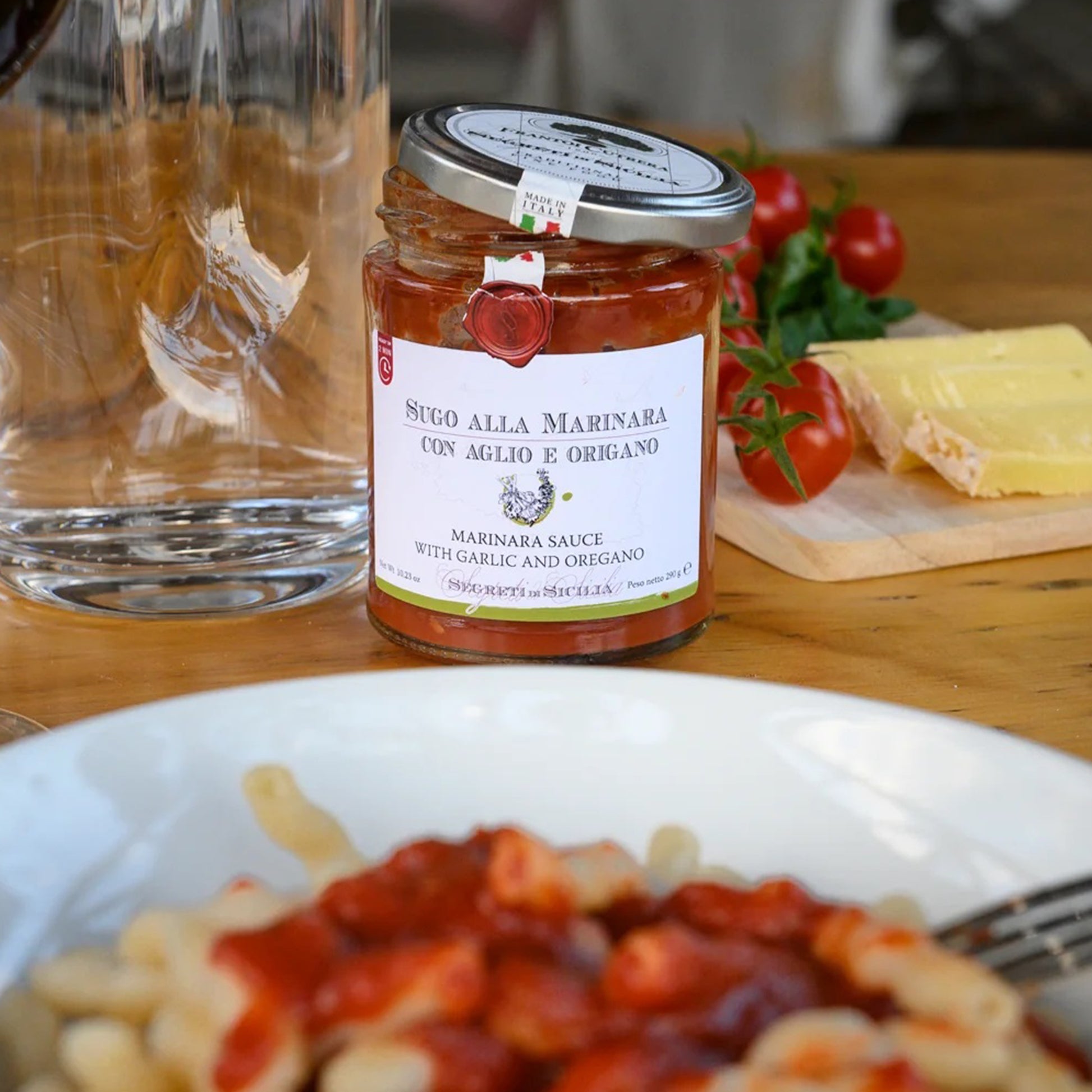Close-up jar of Sicilian marinara sauce with garlic and oregano