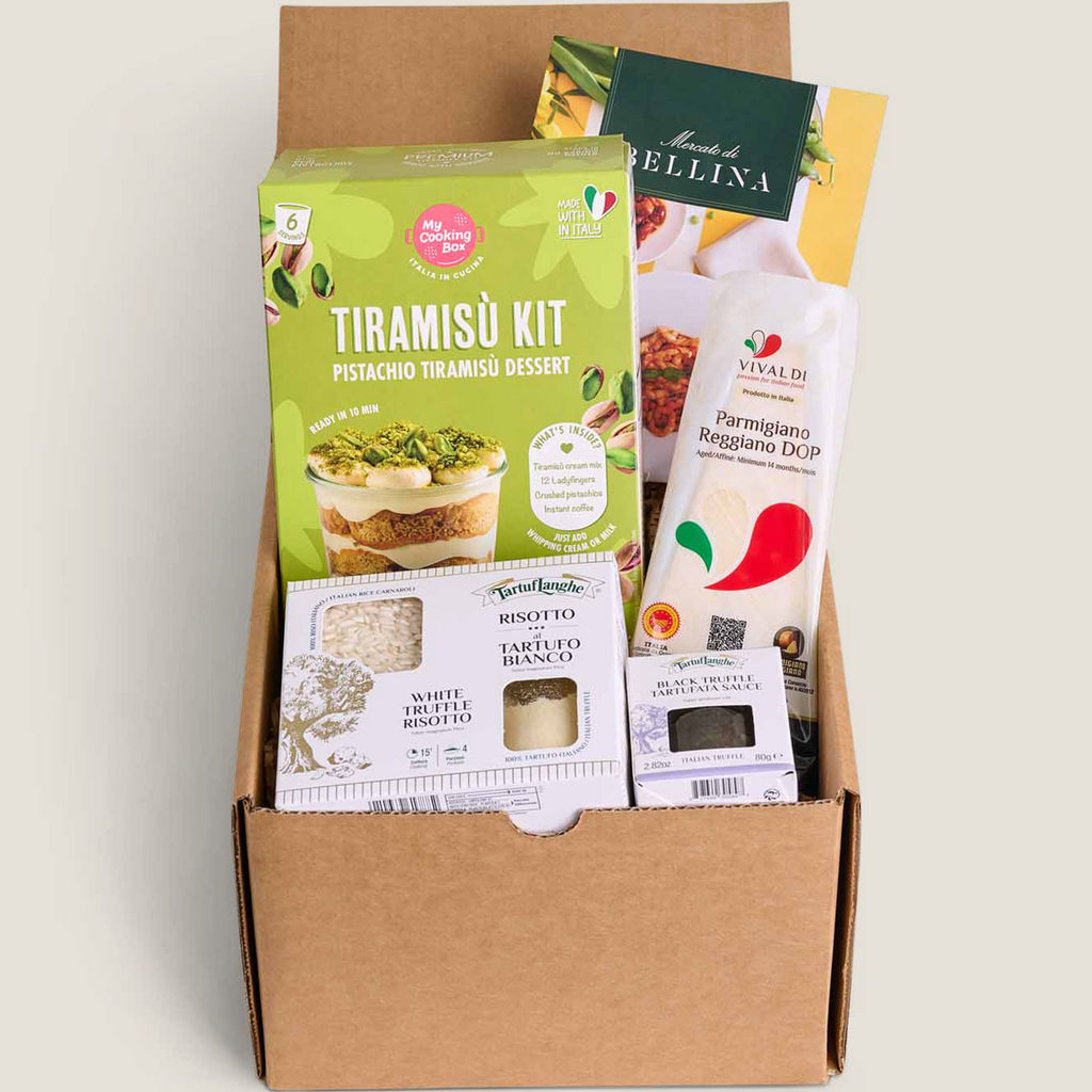 A curated gift box containing a green Tiramisu Kit box, a white Vivaldi parmigiano reggiano DOP cheese, a white trufleRisotto kit, and other packaged snacks and inserts, all arranged in a brown cardboard box on a white background.