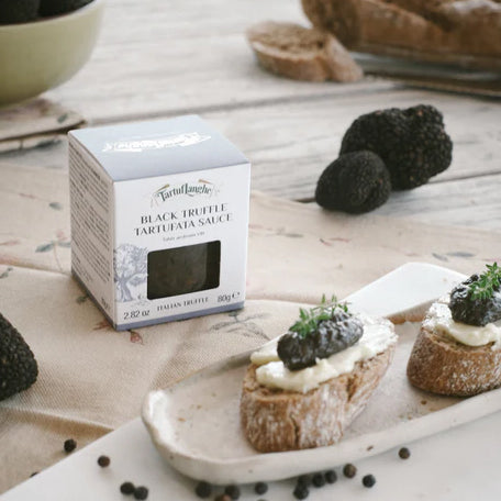 Black truffle tartufata sauce jar with crostini topped with truffle spread