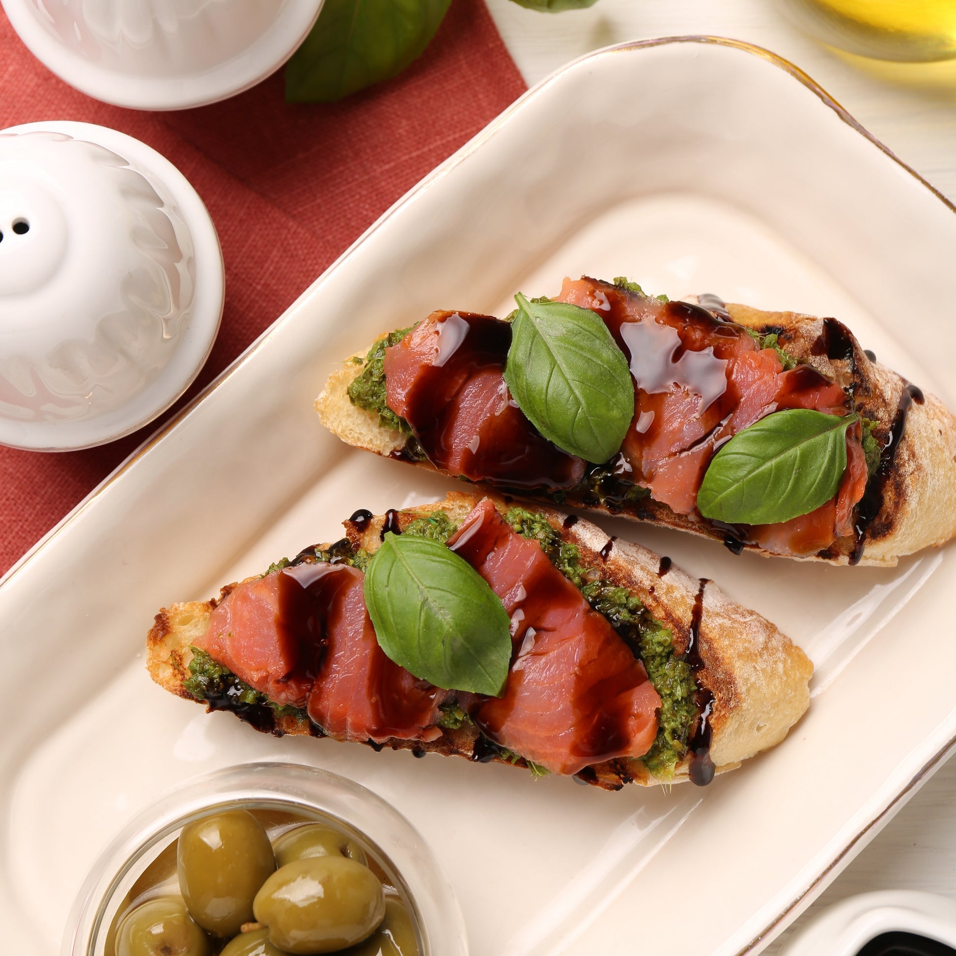 Bruschetta with smoked salmon, basil, and Giusti Organic Balsamic Vinegar drizzle