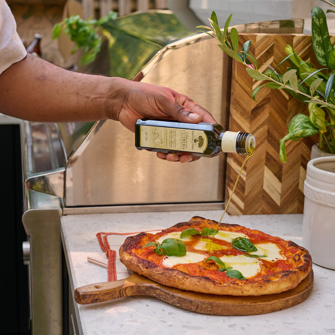 Fresh pizza made with Molino Rossetto gluten free dough topped with basil and olive oil