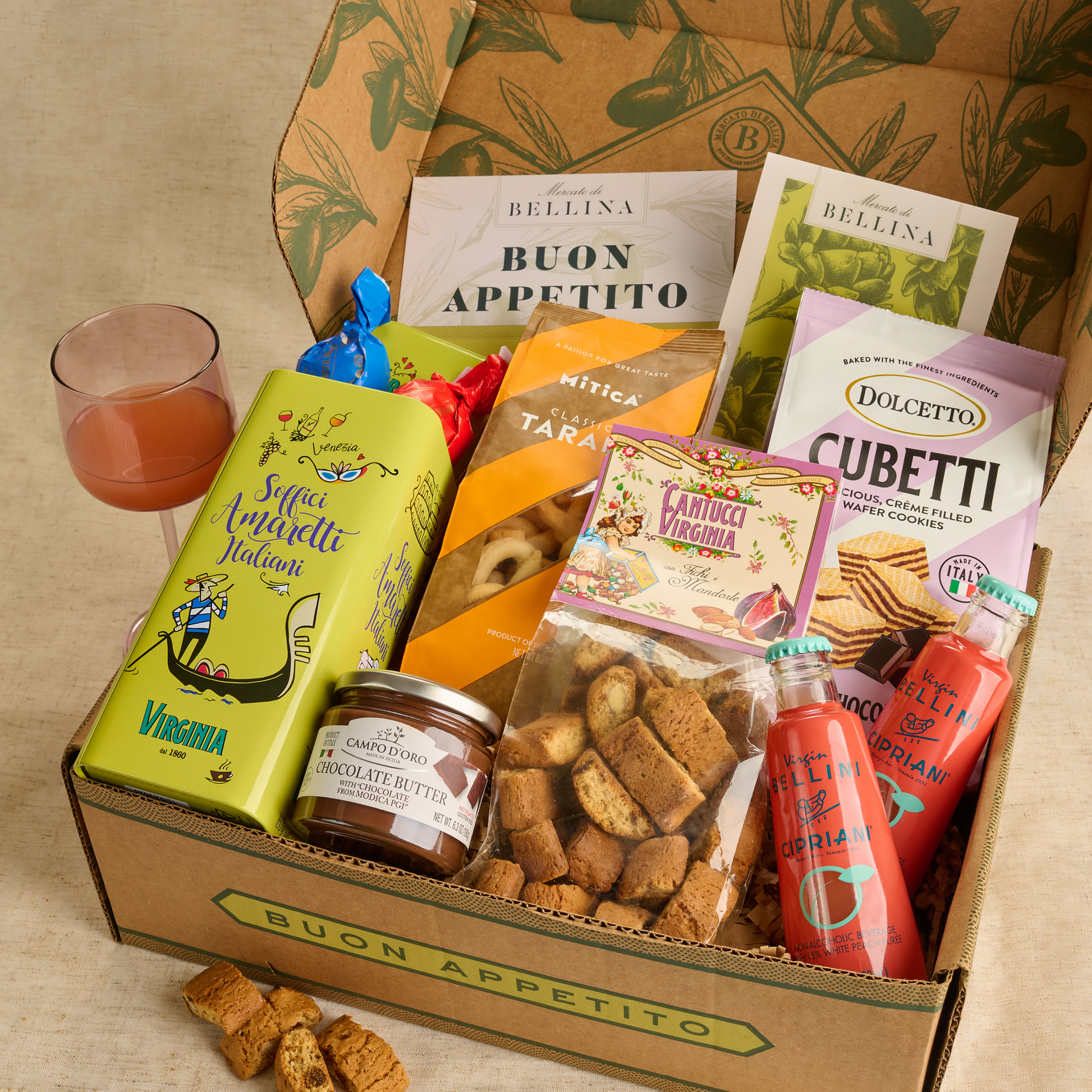 Open Bellina gift box with taralli, biscotti, wafers, Bellini drinks, and chocolate butter