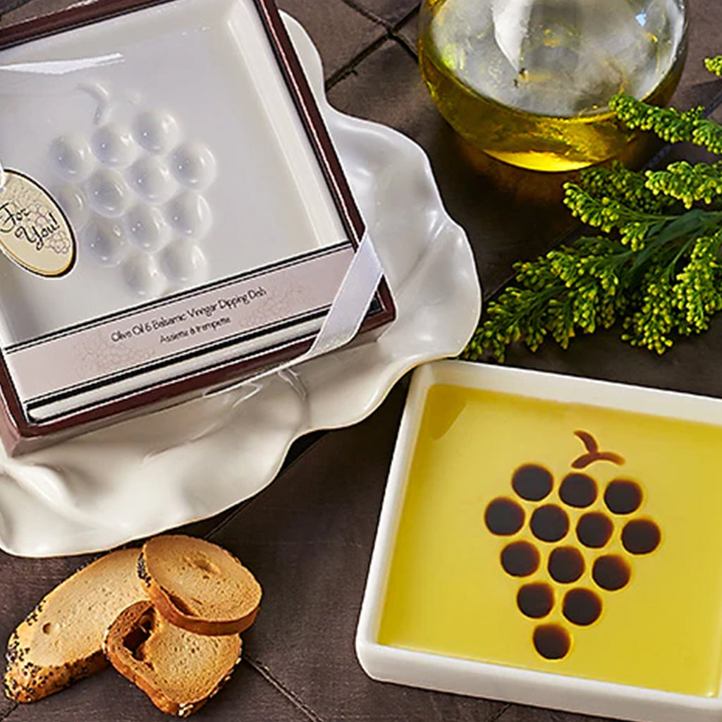 Ceramic dipping dish with grape design filled with olive oil and balsamic vinegar