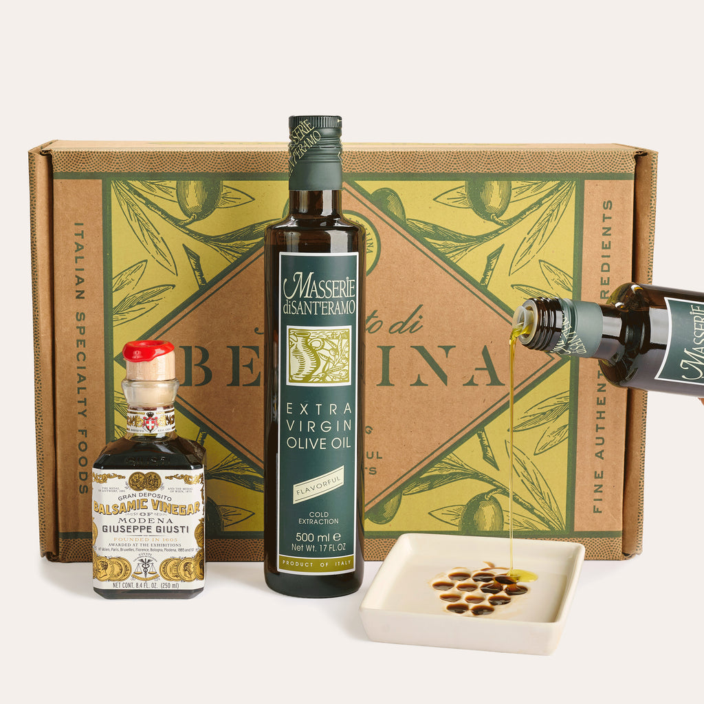 Olive oil and balsamic vinegar bottles with dipping dish in front of Bellina box