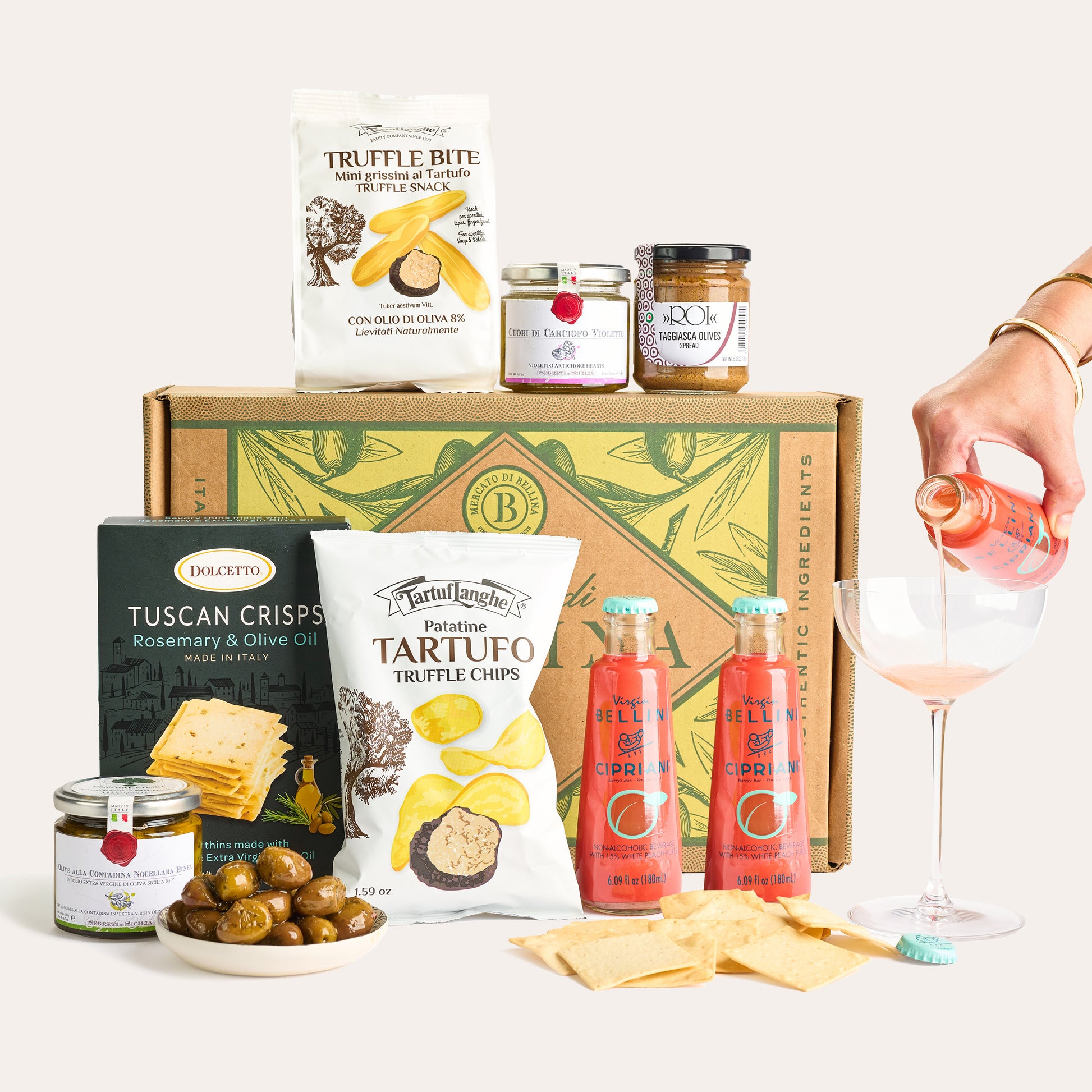 Italian Aperitivo Box featuring truffle chips, Tuscan crisps, olives, and Bellini drinks