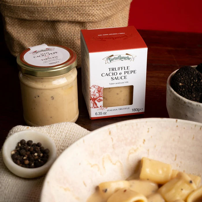 Tartuflanghe truffle cacio e pepe sauce jar with rigatoni pasta and peppercorns