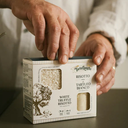 White truffle risotto box with hands preparing Italian risotto