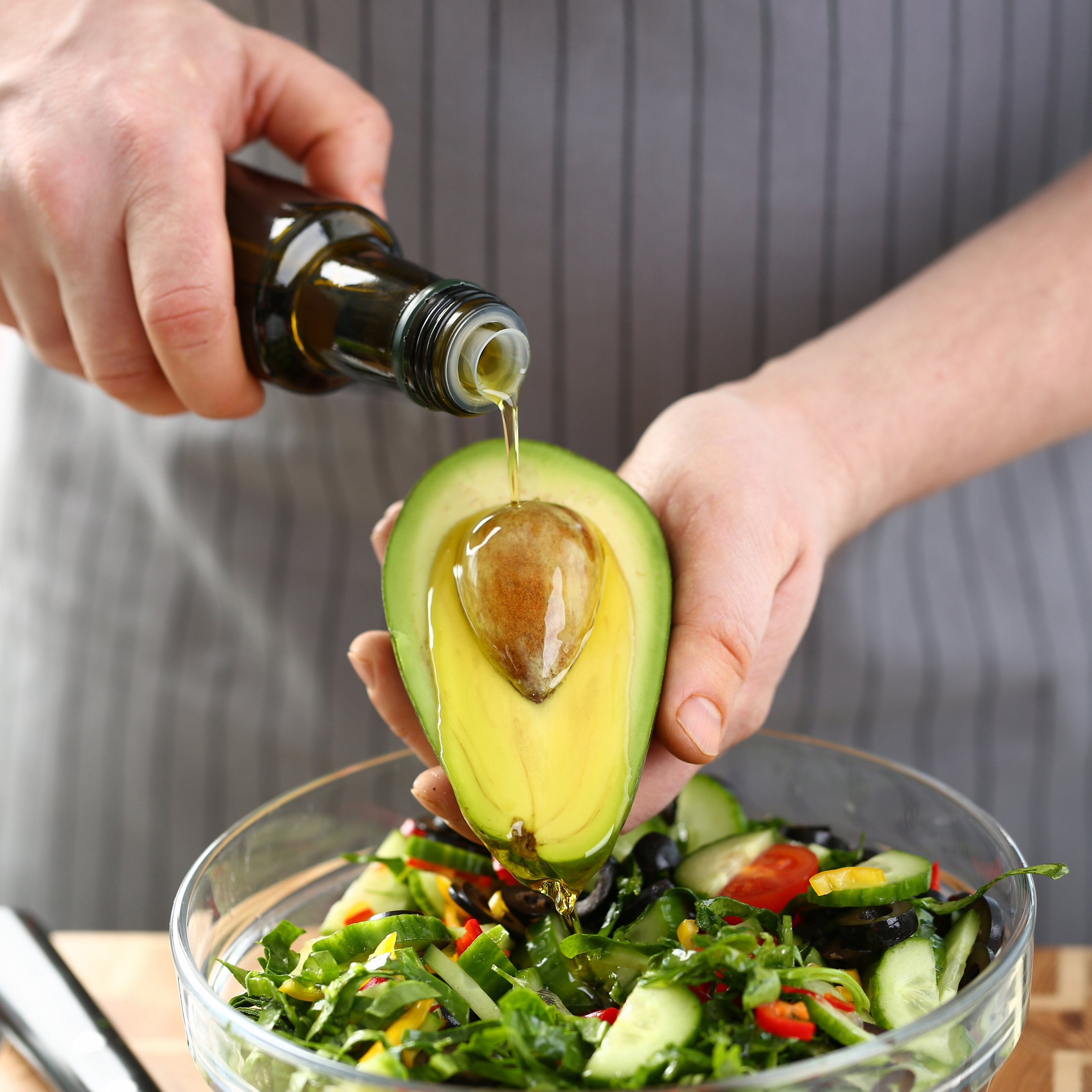 Golden Extra Virgin Olive Oil in a spoon, showcasing its smooth texture, Masserie di Santeramo