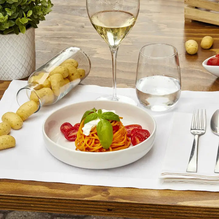 Italian aperitivo table with Imacoritti Grissini Bites, pasta dish, and white wine